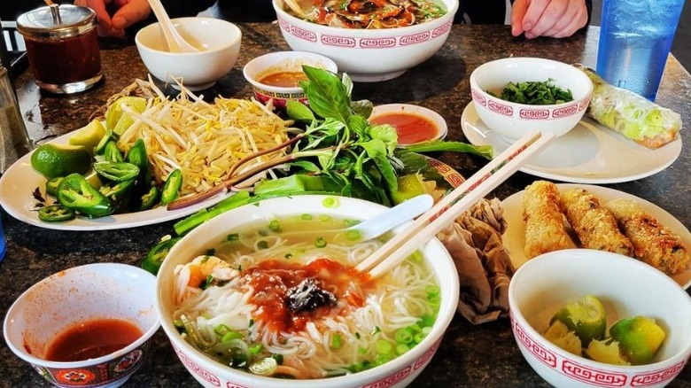 table of pho and other Vietnamese food