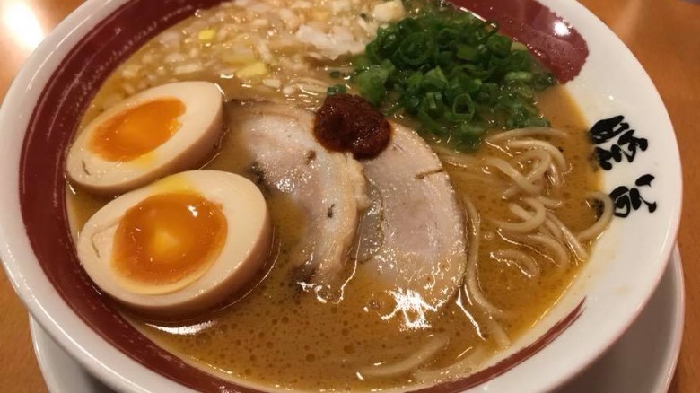 Green onions sliced pork and soft boiled egg in broth