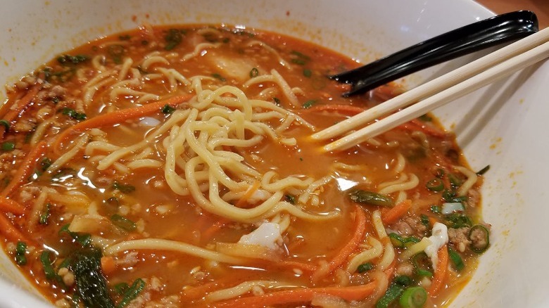 bowl of red broth and noodles