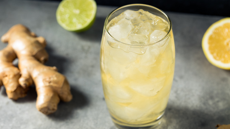 A glass of ginger ale with ginger roots