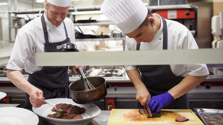 chefs cooking steak