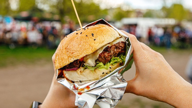 cheeseburger in foil outdoors 