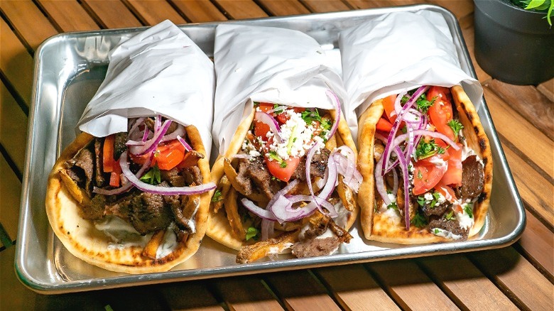 three gyros on metal tray