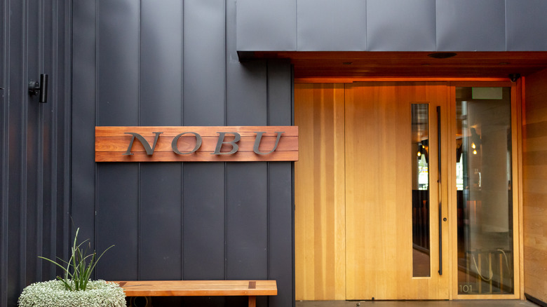 Brown wooden storefront reading NOBU