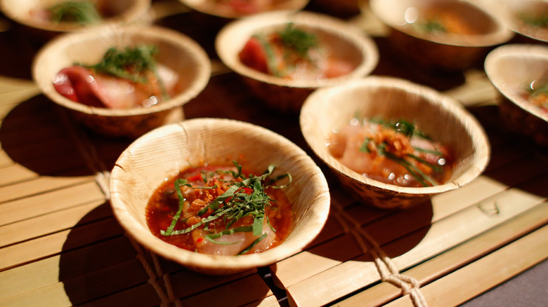 Small bamboo bowls of marinated pink sushi