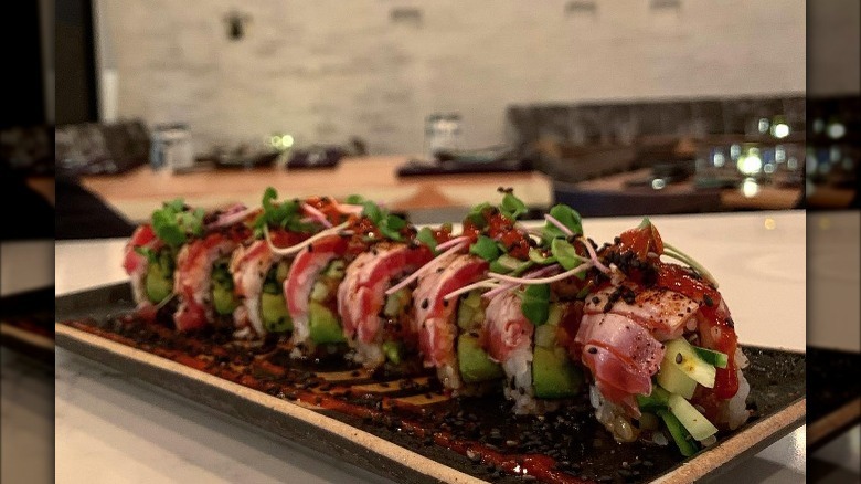 Pink tuna topped sushi filled with green avocado