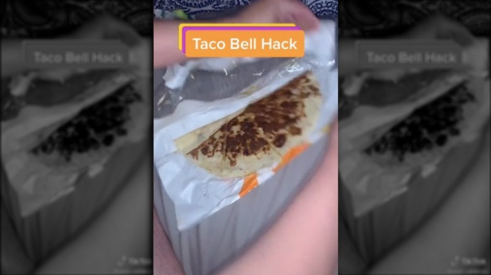 A shot of the TikTok user ripping his Taco Bell bag