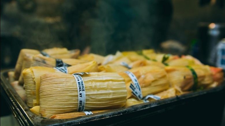 steamy city tamales stacked in a metal pan