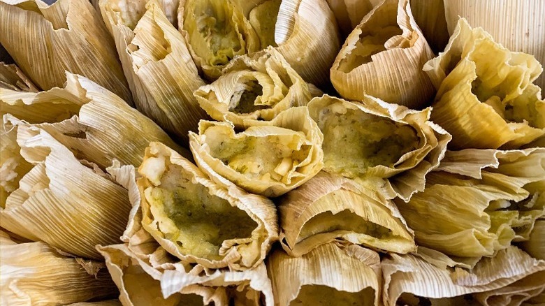 close up picture of tamales wrapped in corn husks