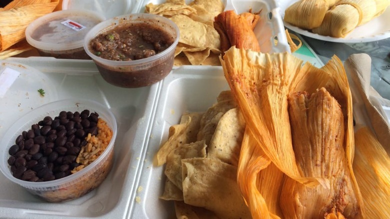 tamale feast with chips salsa black beans and rice