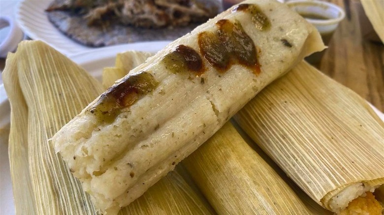 corn masa tamale with green picante sauce on top