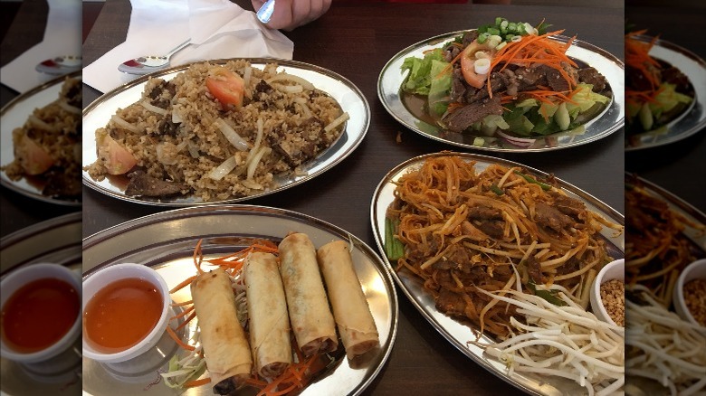 A restaurant table full of Thai food