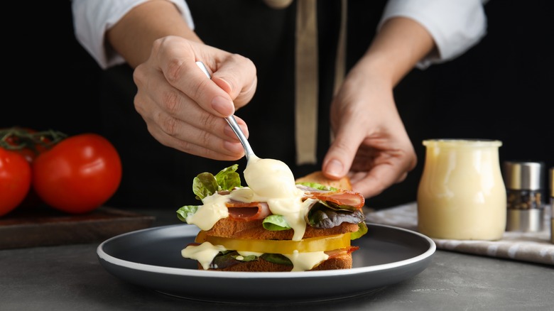 woman making sandwich with mayo