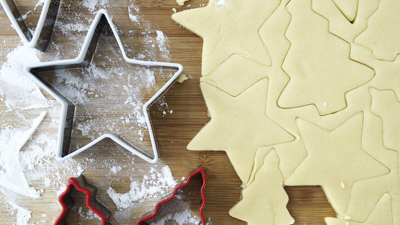 sugar cookie dough rolled out with Christmas cookie cutters