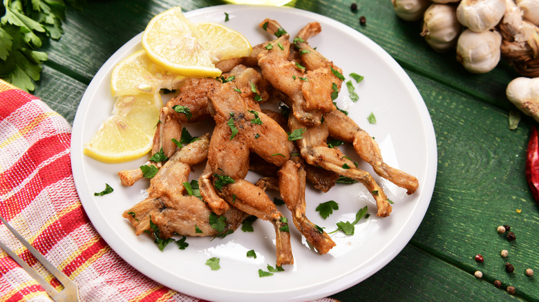 Frog legs meal on plate