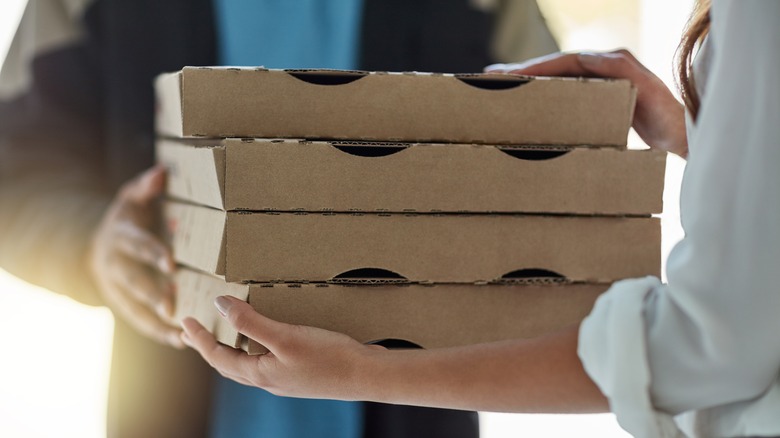 Takeout boxes being handed over