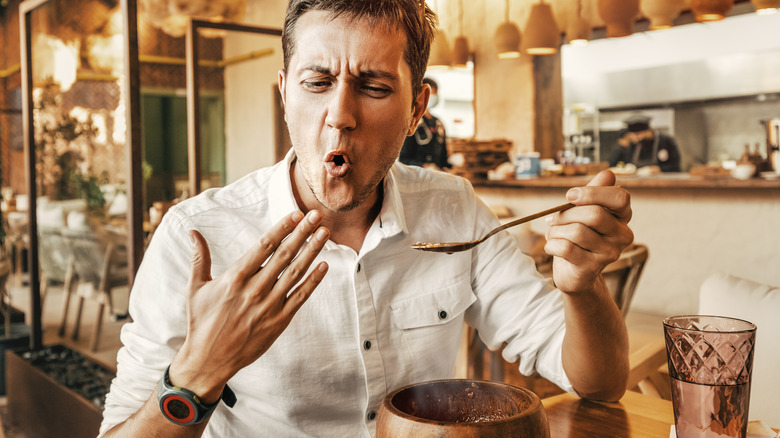 Man eating spicy food 