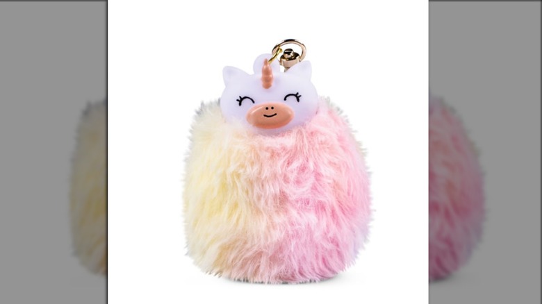 A hand sanitizer and keychain shaped like a unicorn