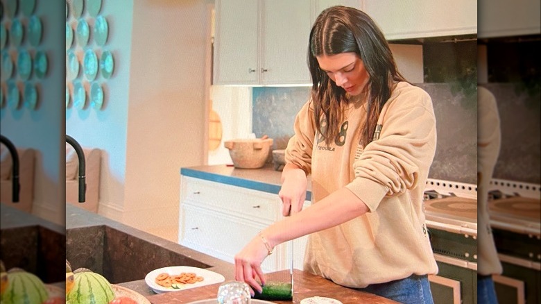 Kendall Jenner cutting a cucumber