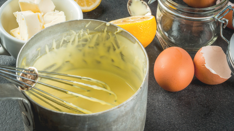 Whisking hollandaise sauce in a pot