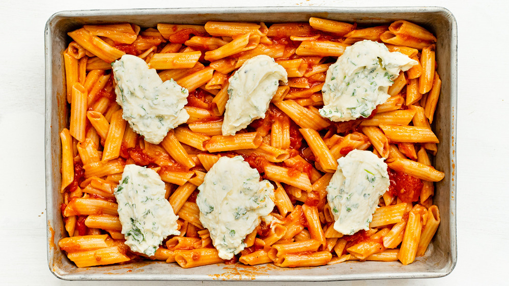 Herbed ricotta on top of ziti in pan