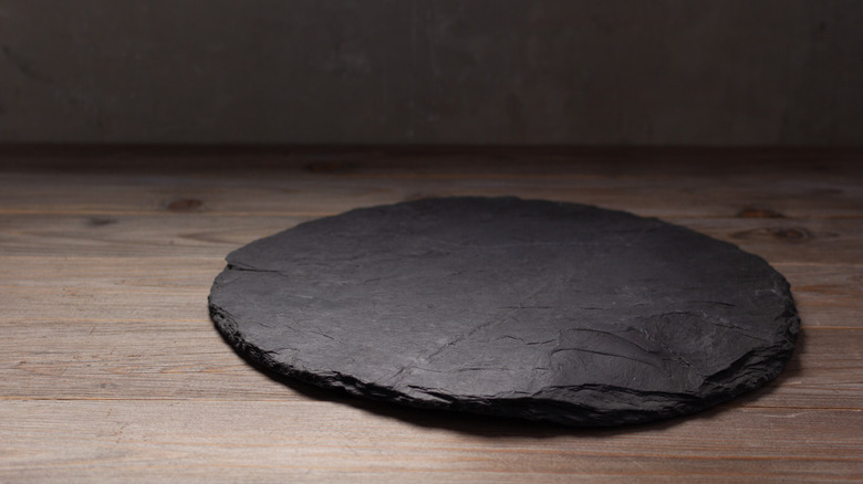 Empty pizza stone on a wooden table