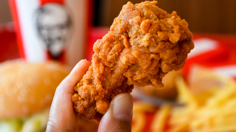 hand holding KFC fried chicken