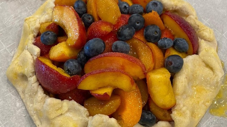 Tart with peaches, apricots, and blueberries