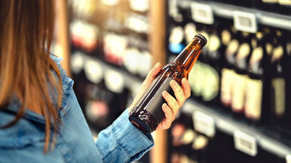 Customer considering beer in a store