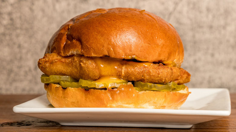 Fish sandwich with fries on table