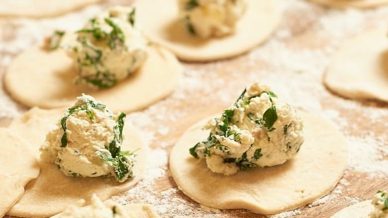 Pierogi's on a table with flour 