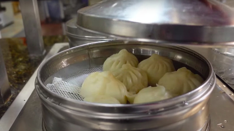 Lifting off a dumpling lid