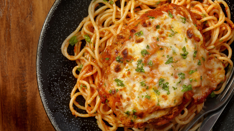 chicken parmesan on black plate