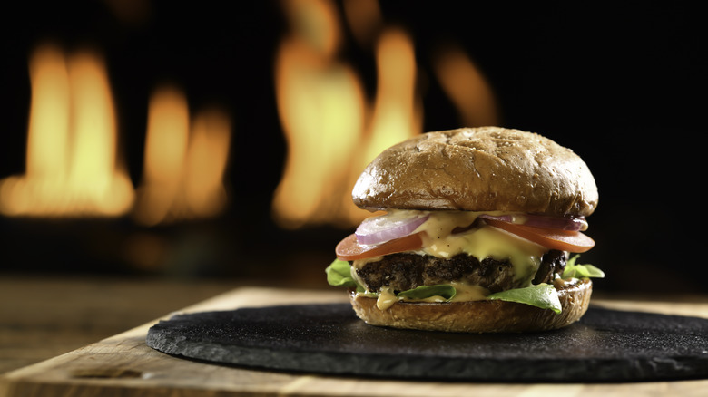 cheeseburger on black platter