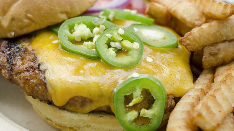 Pile of jalapeños on cheeseburger