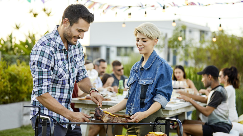 people getting food at bbq