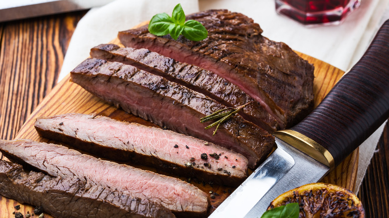 Sliced flank steak on a cutting board