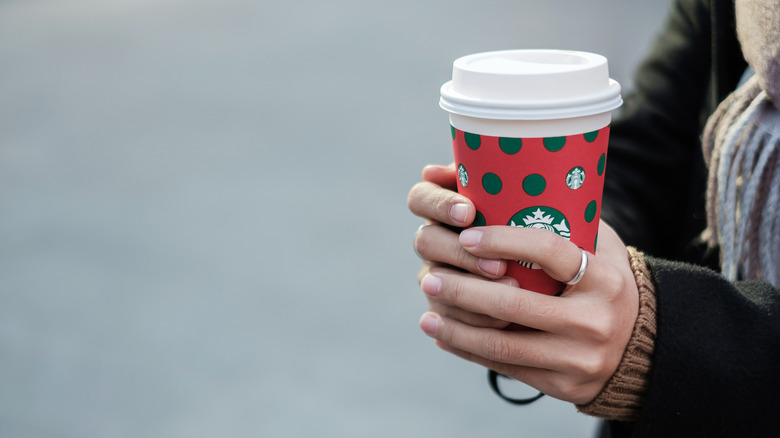 person holding Starbucks cup