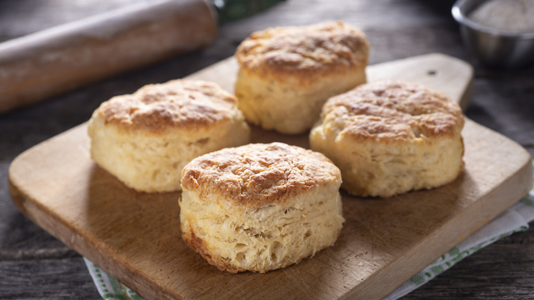 Four biscuits on cutting board