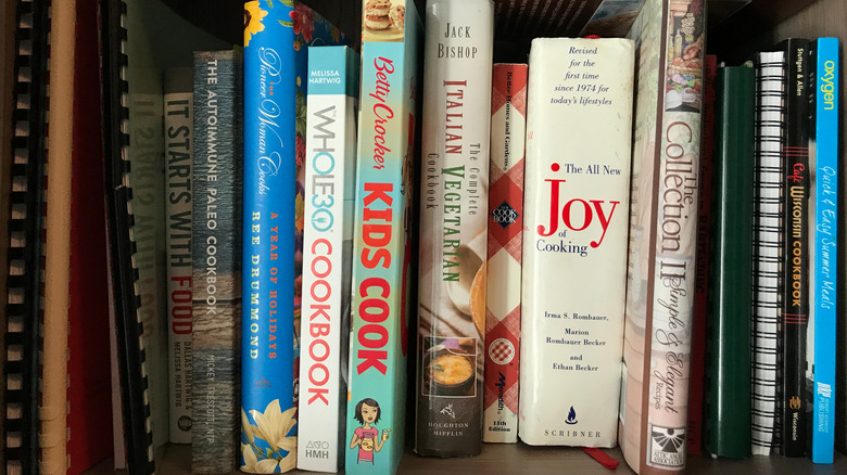 A shelf with many cookbooks