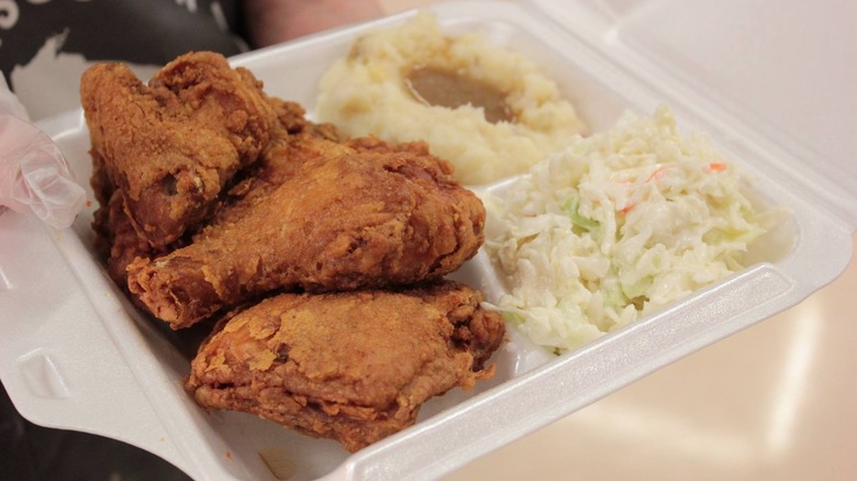 Fried chicken in Styrofoam with coleslaw and other sides