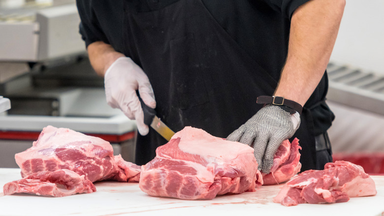 employee slicing meat 