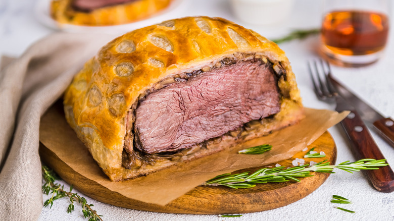 plate of beef Wellington garnished with herbs