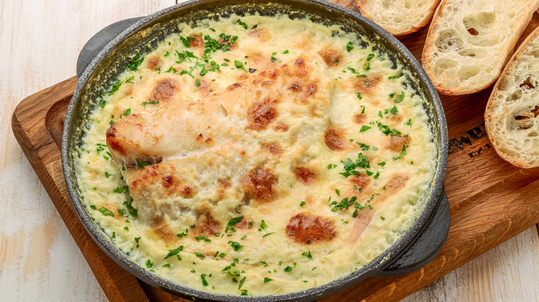 white fish casserole with herb garnish