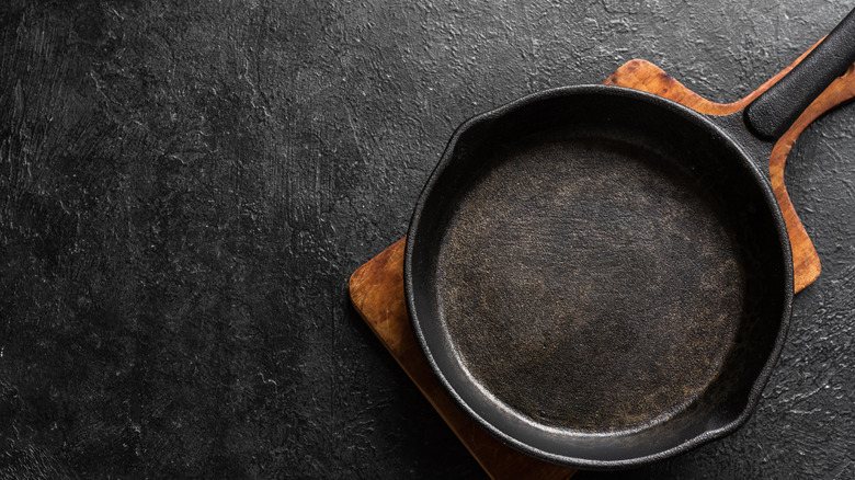 empty cast iron pan on black countertop