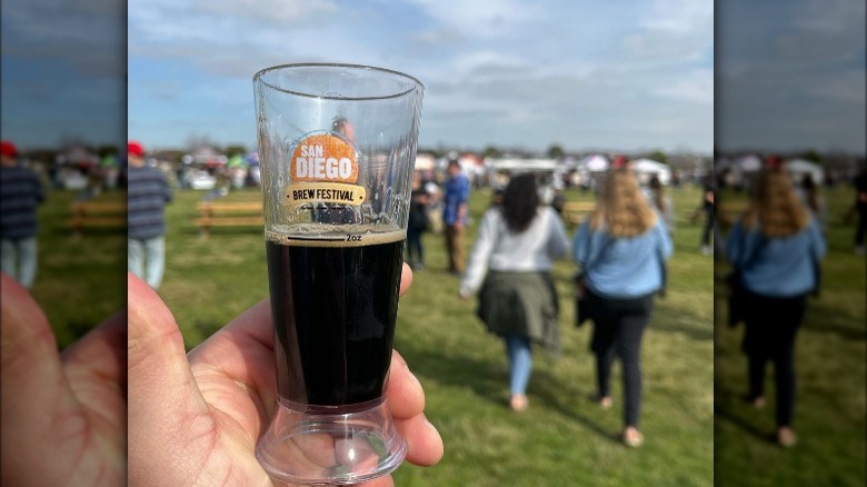 Person hold beer glass at festival 