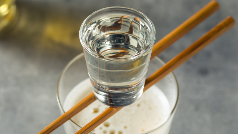 shot glass balanced on chopsticks