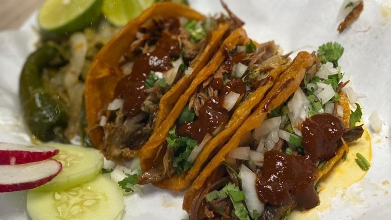 Birria tacos with red sauce