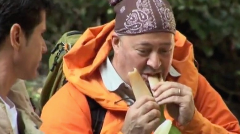 Andrew Zimmern wearing orange outdoors