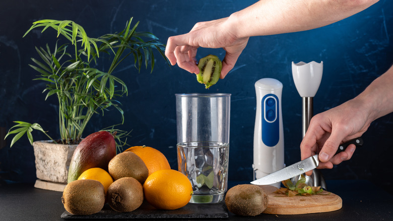 Cut fruit beside a hand blender